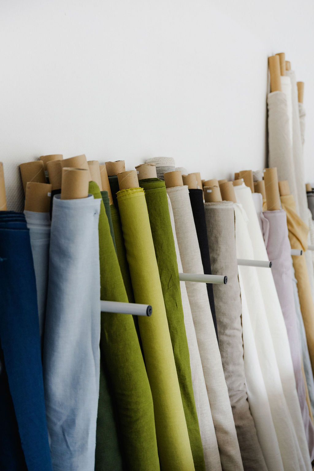 Rolls of linen fabric in various colors by yard and by meter