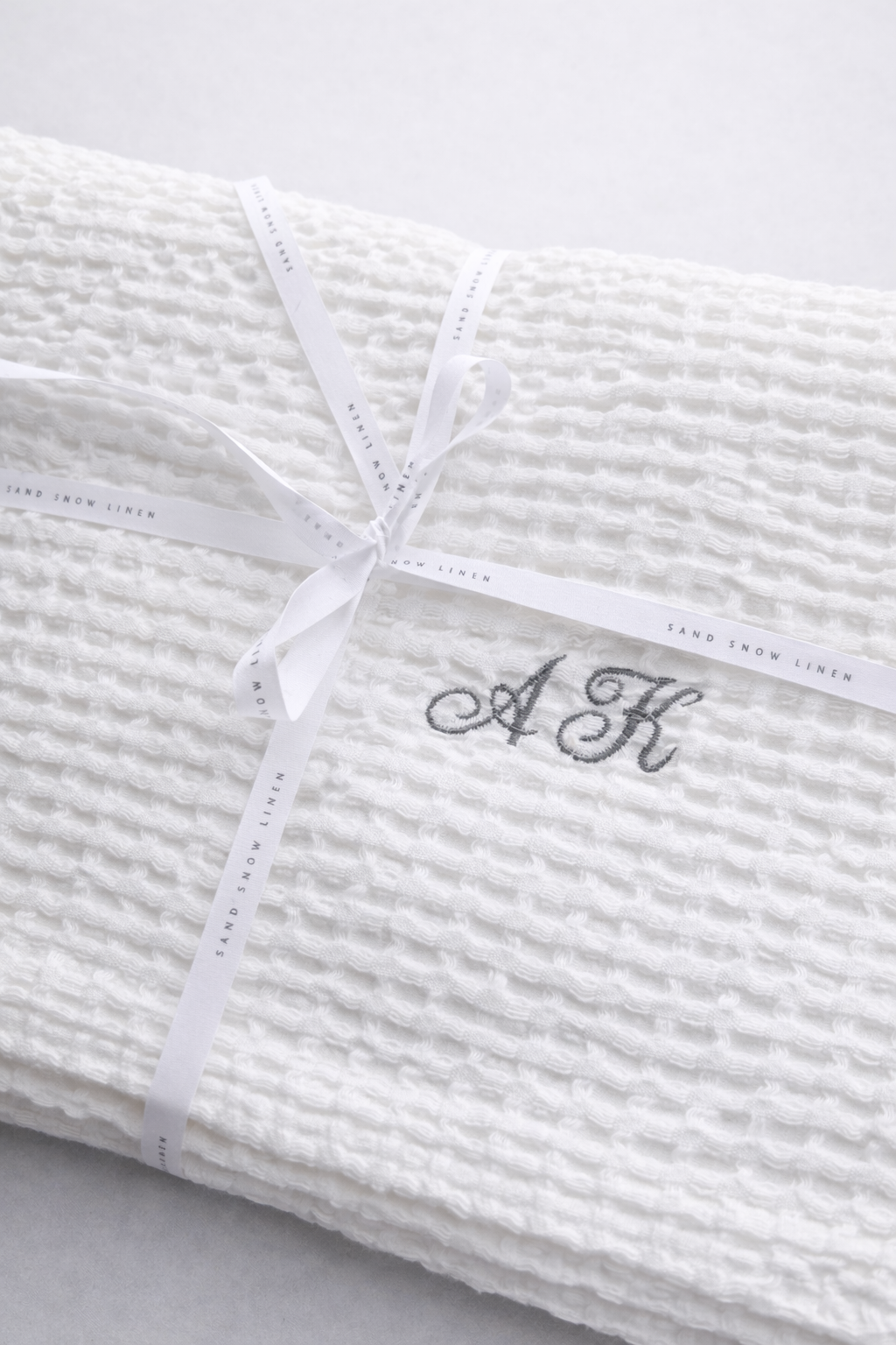 White linen cotton waffle towel with embroidered initials