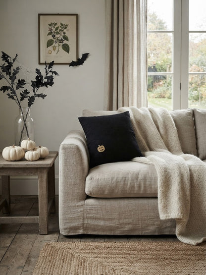 black halloween pillow with pumpkin