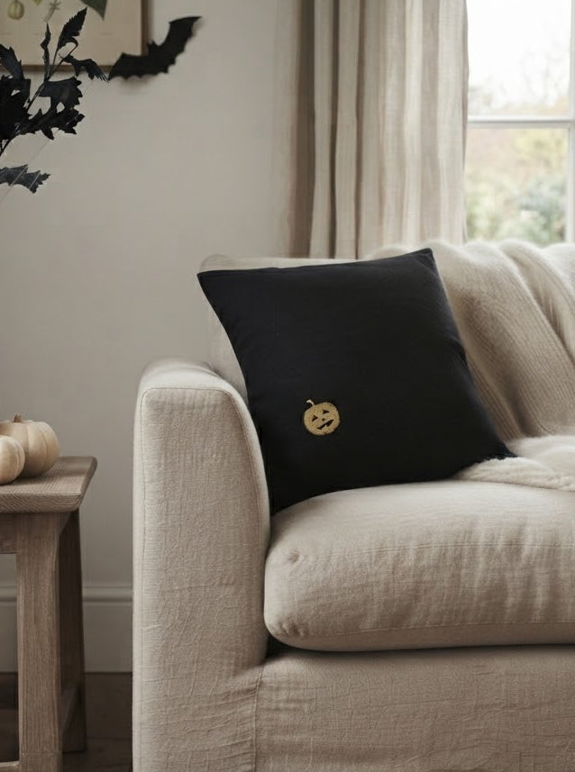 black halloween pillow with pumpkin