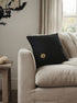 black halloween pillow with pumpkin