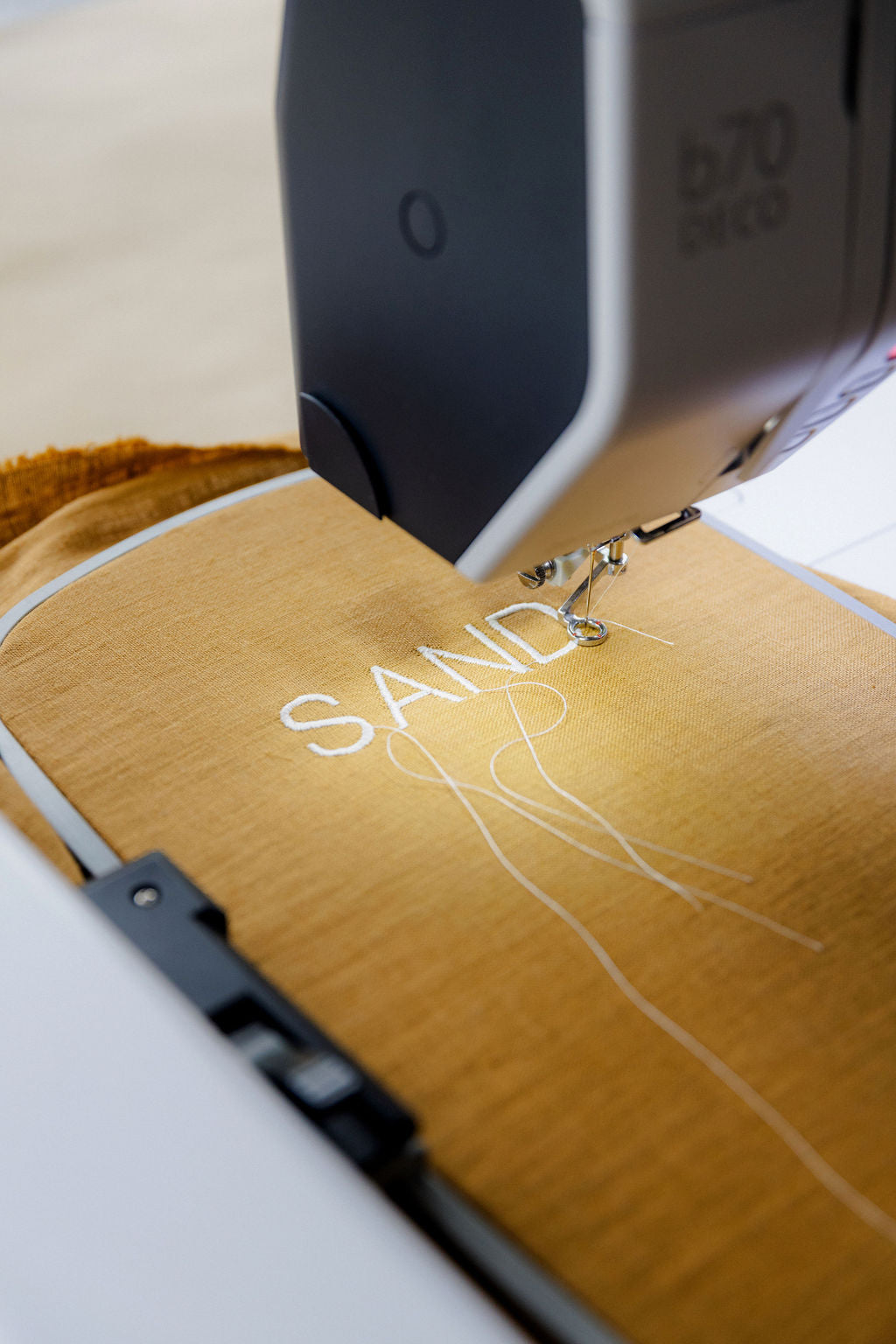 Sewing machine stitching the word &