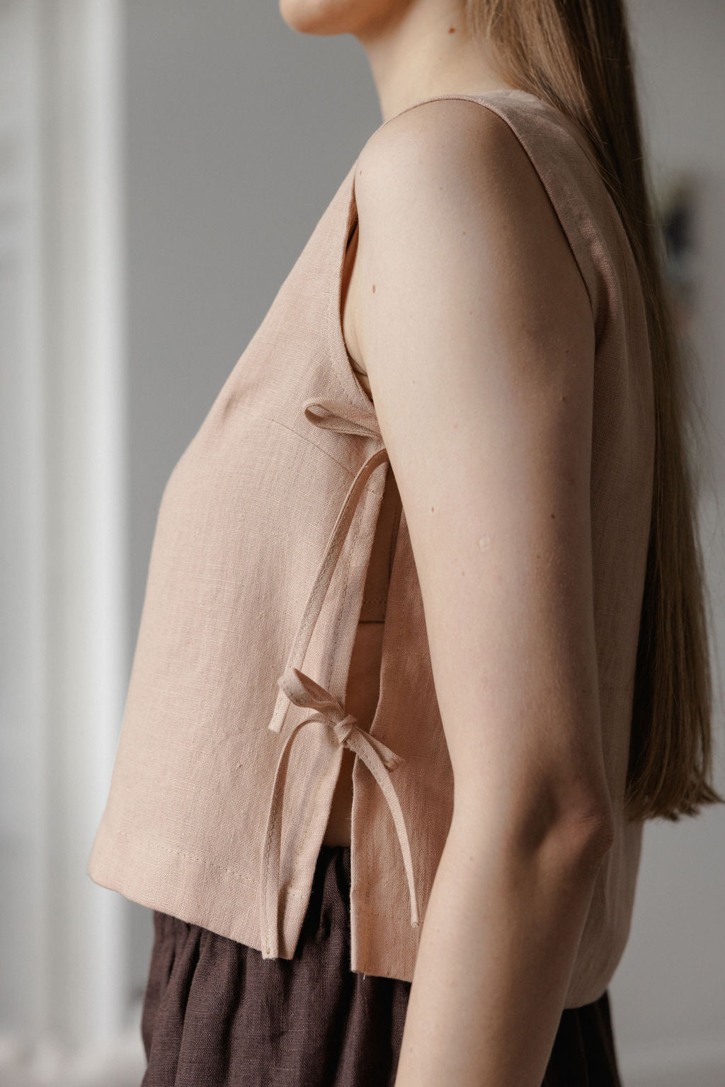 Sleeveless linen top with side tie details in peach linen