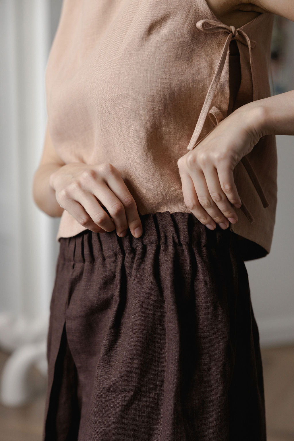 Sleeveless linen top with side tie details in peach linen